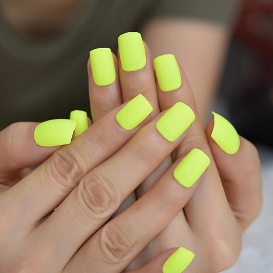 24 short press-on nails in electric neon green and yellow matte finish, bright summer rave party style with 80s retro vibes surethings