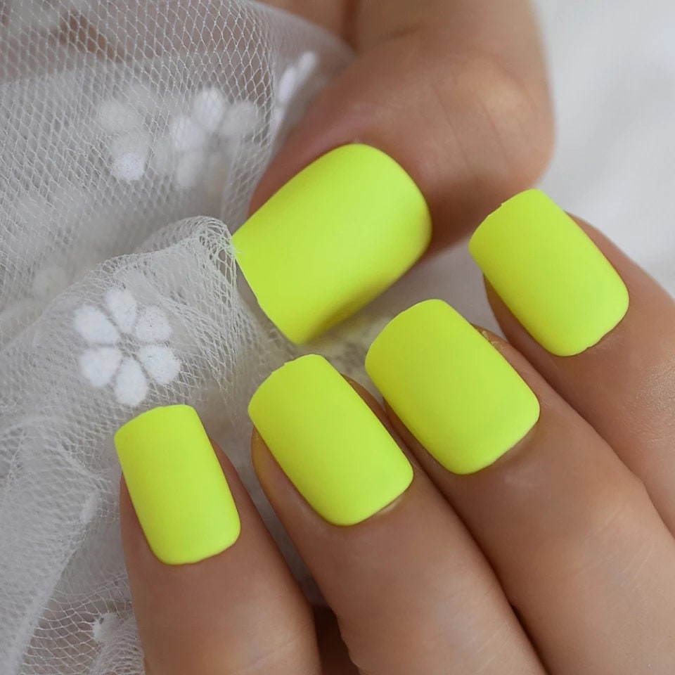 24 short press-on nails in electric neon green and yellow matte finish, bright summer rave party style with 80s retro vibes surethings