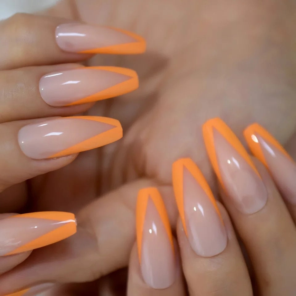 24 long press on nails with neon orange V-tip French design, nude base, rave coffin shape surethings