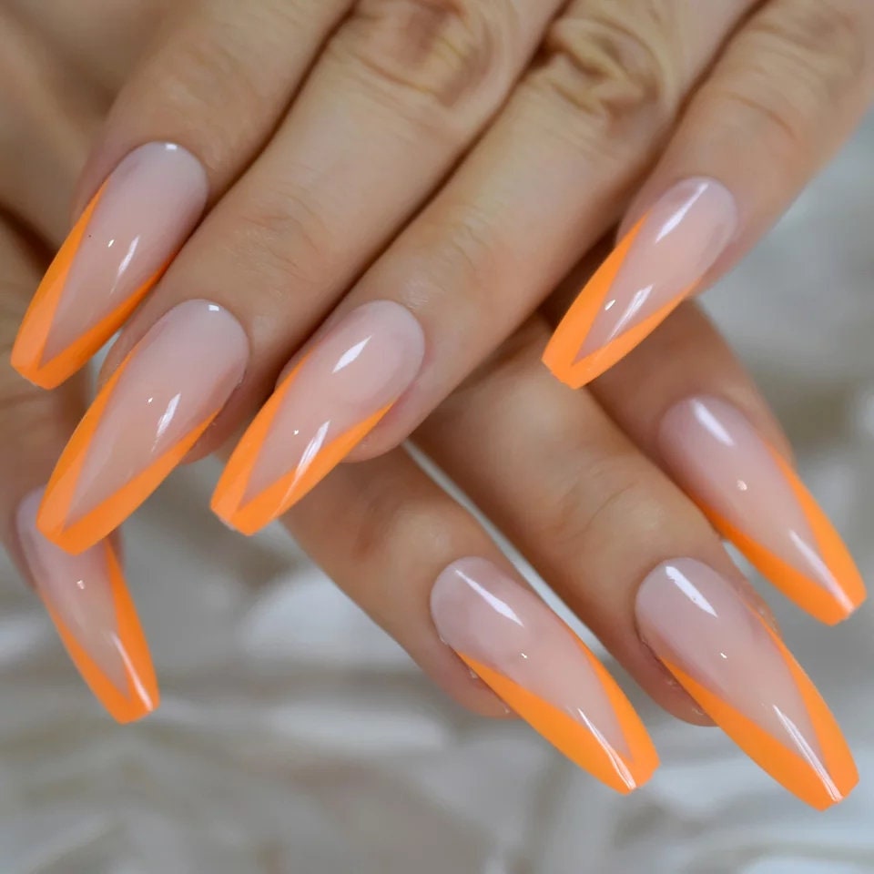 24 long press on nails with neon orange V-tip French design, nude base, rave coffin shape surethings