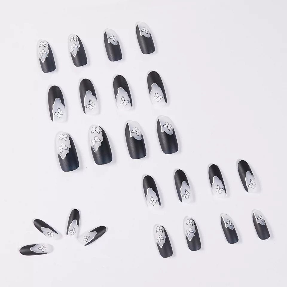 24 long press-on nails with matte black and white ombre butterfly design, gothic style with almond and round shapes, metallic line accents surethings