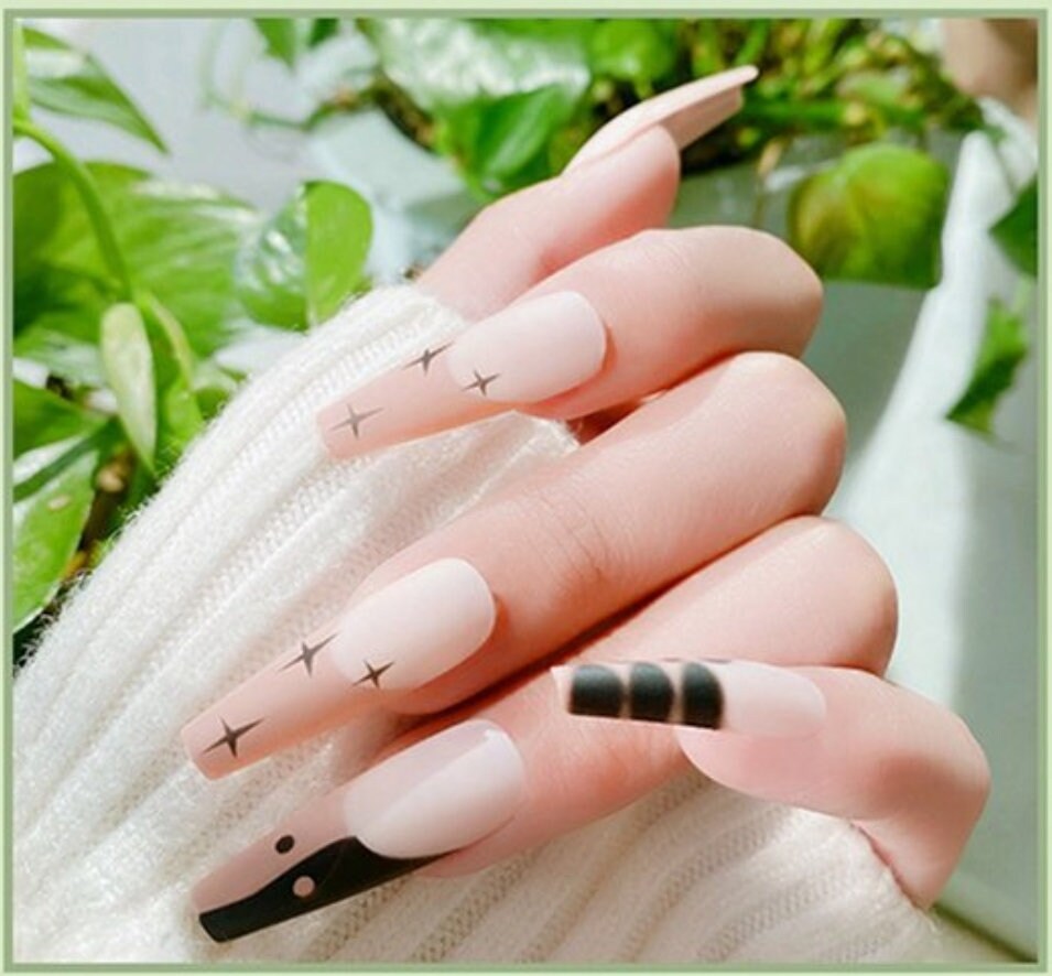 24 extra long press-on nails in matte tan nude coffin shape with black flame and brown design surethings