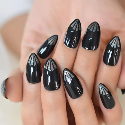 A hand showcasing glossy black almond nails with a minimalist aesthetic, perfect for trendy manicure inspiration