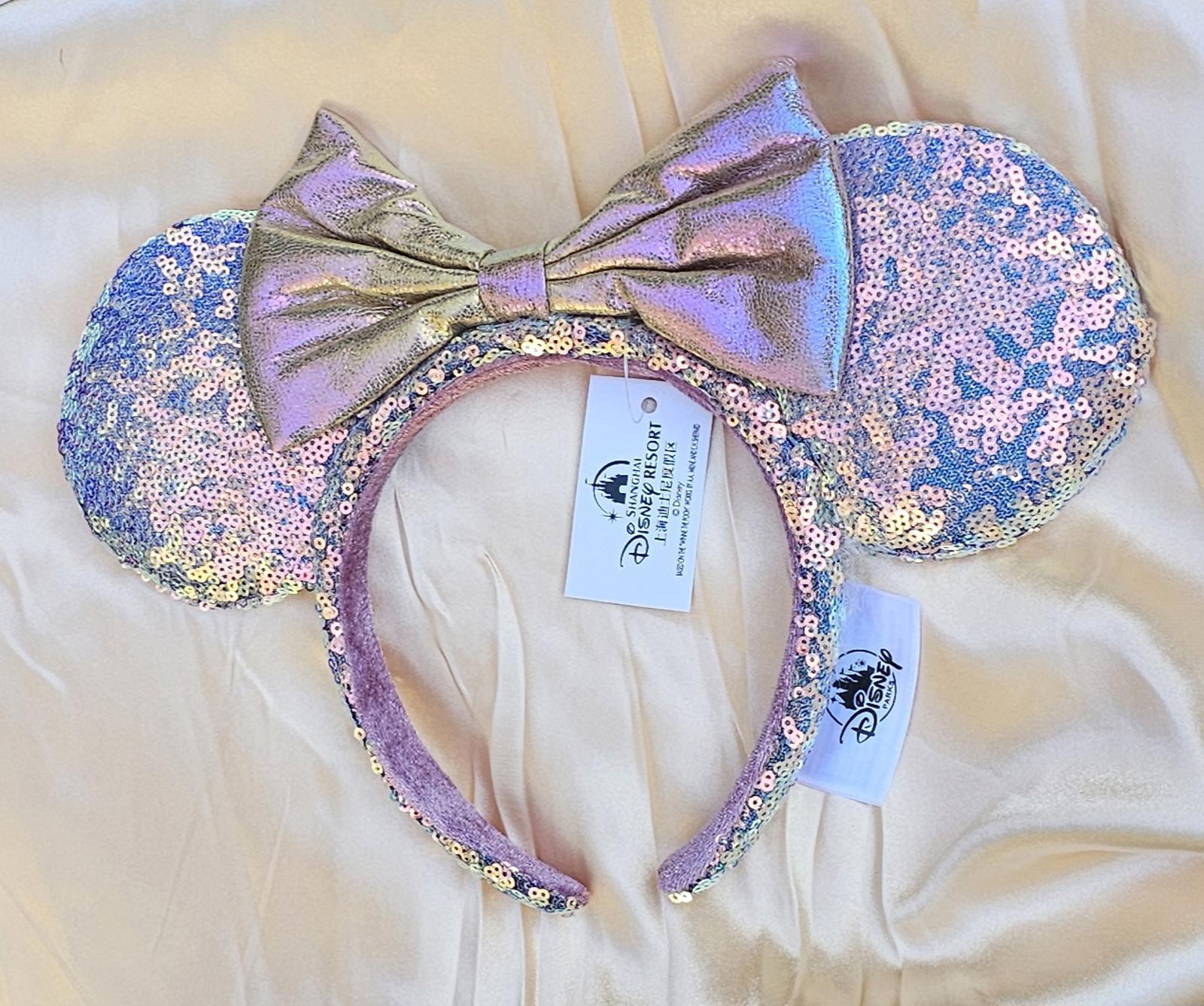 Close-up of Holographic Pink Gold Sequin Minnie Ears Disney Parks headband with iridescent Mickey Mouse Pink bow and shimmering sequins surethings