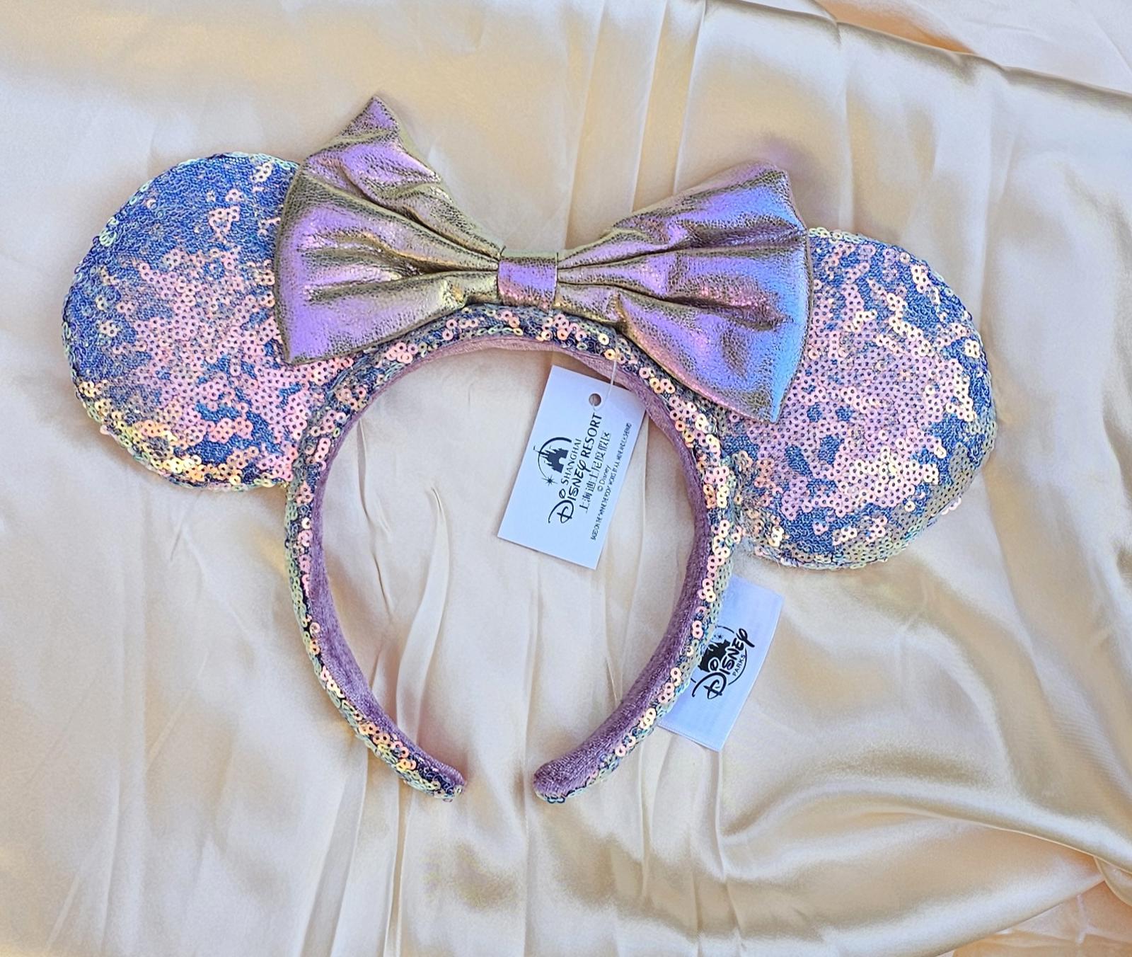 Close-up of Holographic Pink Gold Sequin Minnie Ears Disney Parks headband with iridescent Mickey Mouse Pink bow and shimmering sequins surethings