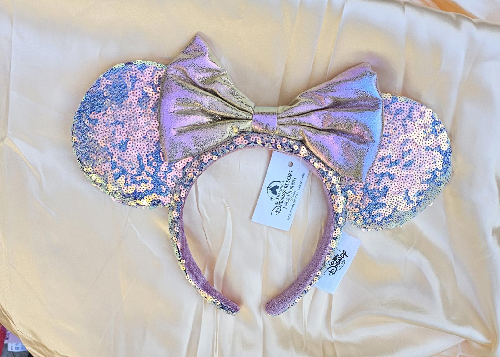 Close-up of Holographic Pink Gold Sequin Minnie Ears Disney Parks headband with iridescent Mickey Mouse Pink bow and shimmering sequins surethings